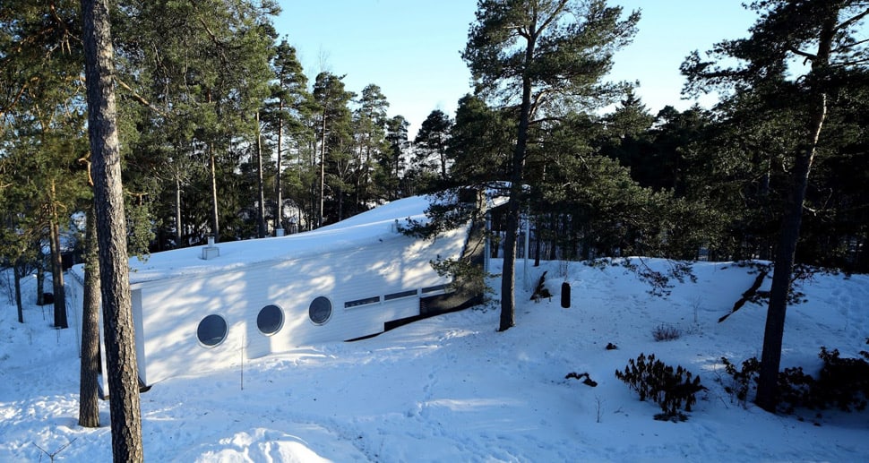 Minimalist wood boat house floating in Finland forest